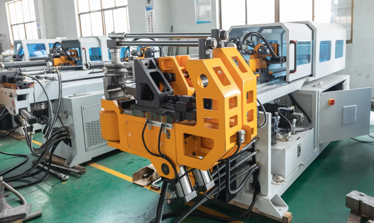 Mandrel and wiper die tool set up inside a CNC tube bender